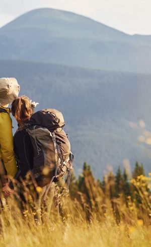 Beautiful young people travel together. Majestic Carpathian Mountains. Beautiful landscape of untouched nature.